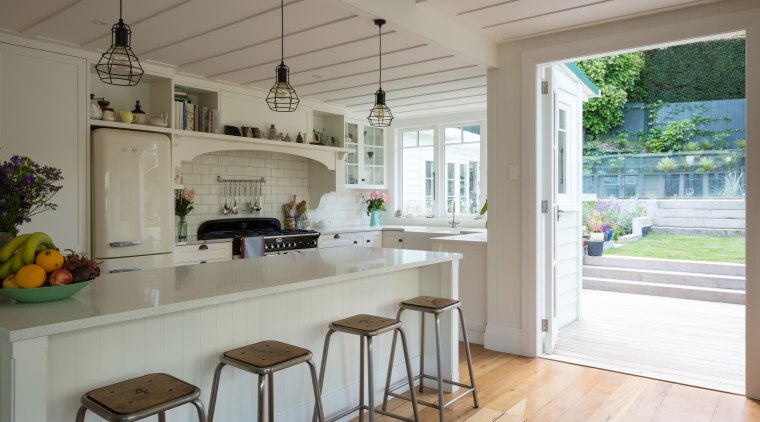 Classic elements like panel doors, brass pulls, subway countertop, estate, floor, home, house, interior design, kitchen, property, real estate, room, window, gray