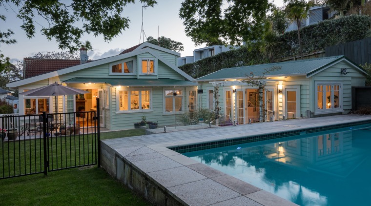 A modest extension beyond this homes envelope provided backyard, cottage, estate, facade, farmhouse, home, house, leisure, lighting, mansion, property, real estate, residential area, swimming pool, villa, gray
