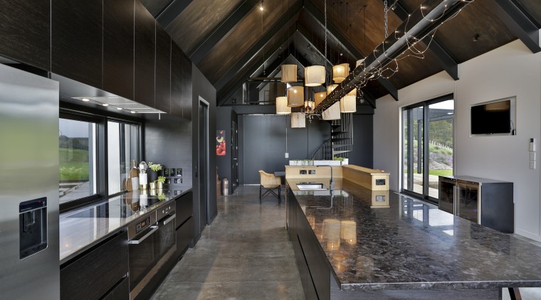 A black understated island benchtop, black-stained veneer cabinetry architecture, countertop, house, interior design, kitchen, loft, black, gray