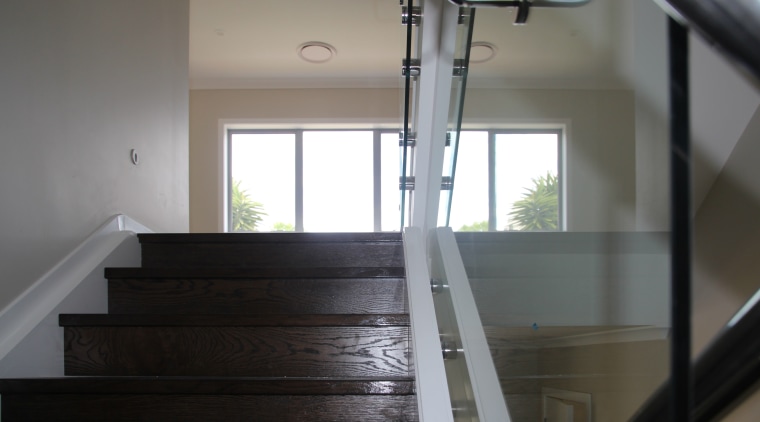 This home features an engineered dark oak staircase daylighting, floor, flooring, glass, handrail, hardwood, house, stairs, wood, gray, black