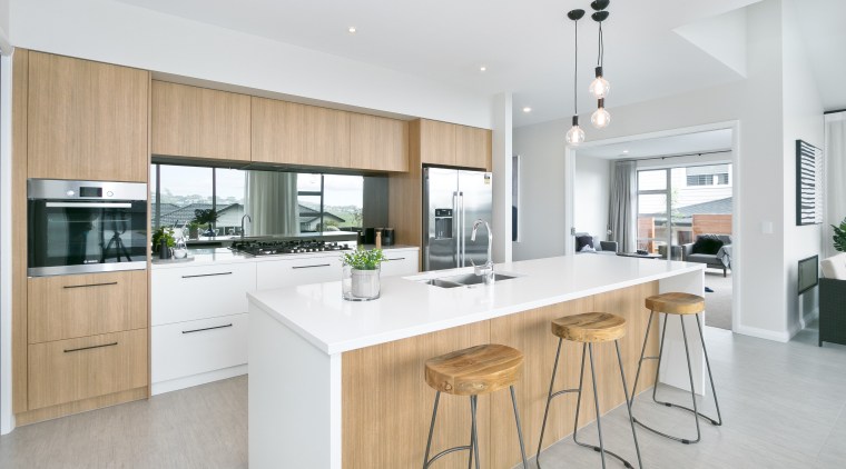 A waterfall-end island, natural-look cabinetry and plenty of countertop, cuisine classique, interior design, kitchen, real estate, white, gray