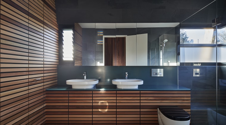 This is one of two identical bathrooms in architecture, bathroom, interior design, room, black, gray