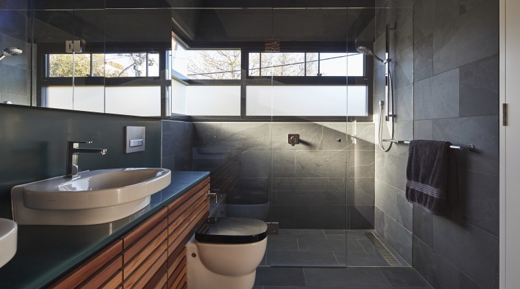 Slate tile flooring and matching wall tiles combine architecture, bathroom, room, black