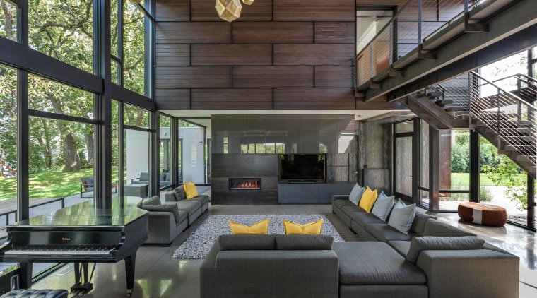 With extensive glazing and exterior materials extending into house, interior design, living room, real estate, black, gray