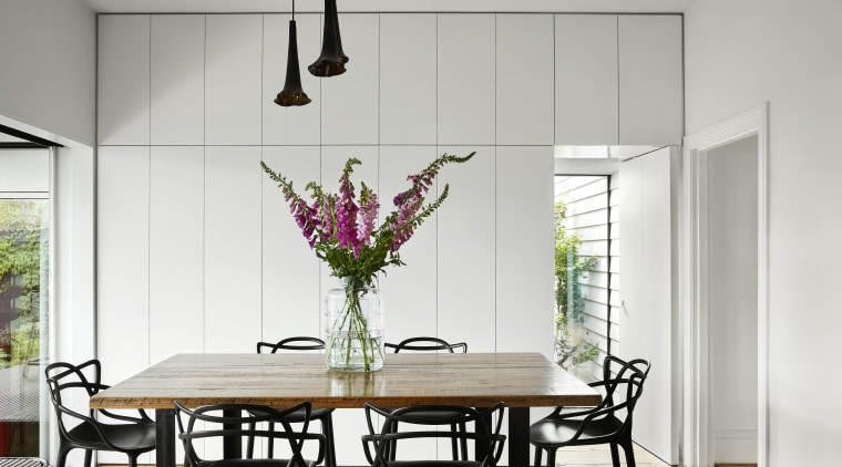 This wooden-top dining table forms part of a dining room, furniture, home, house, interior design, light fixture, room, table, white, gray