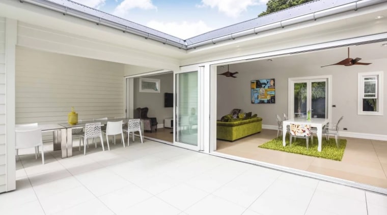 The sheltered outdoor room is ideal for entertaining estate, floor, home, house, property, real estate, window, white