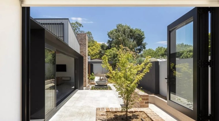 With space at a premium in the suburbs, architecture, courtyard, door, facade, home, house, interior design, property, real estate, window, white, black
