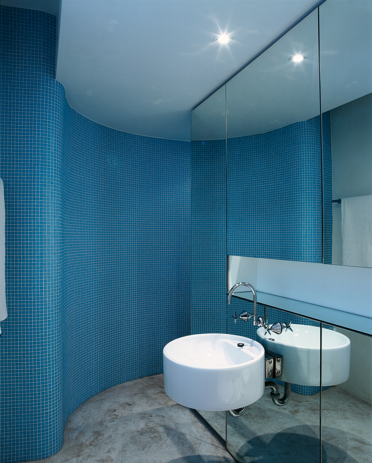 The view of an ensuite with a curved architecture, bathroom, blue, ceiling, daylighting, daytime, floor, glass, interior design, product design, room, tile, wall, teal, blue