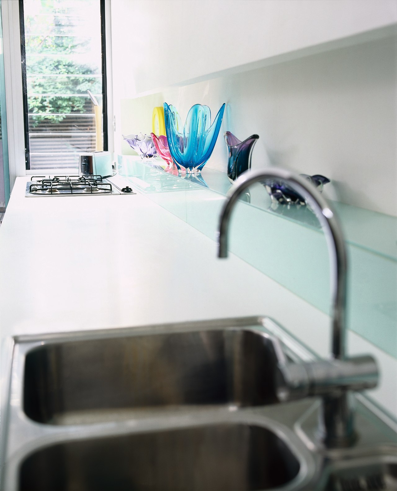 The detail of a sink and benchtop countertop, plumbing fixture, product design, room, sink, table, tap, white