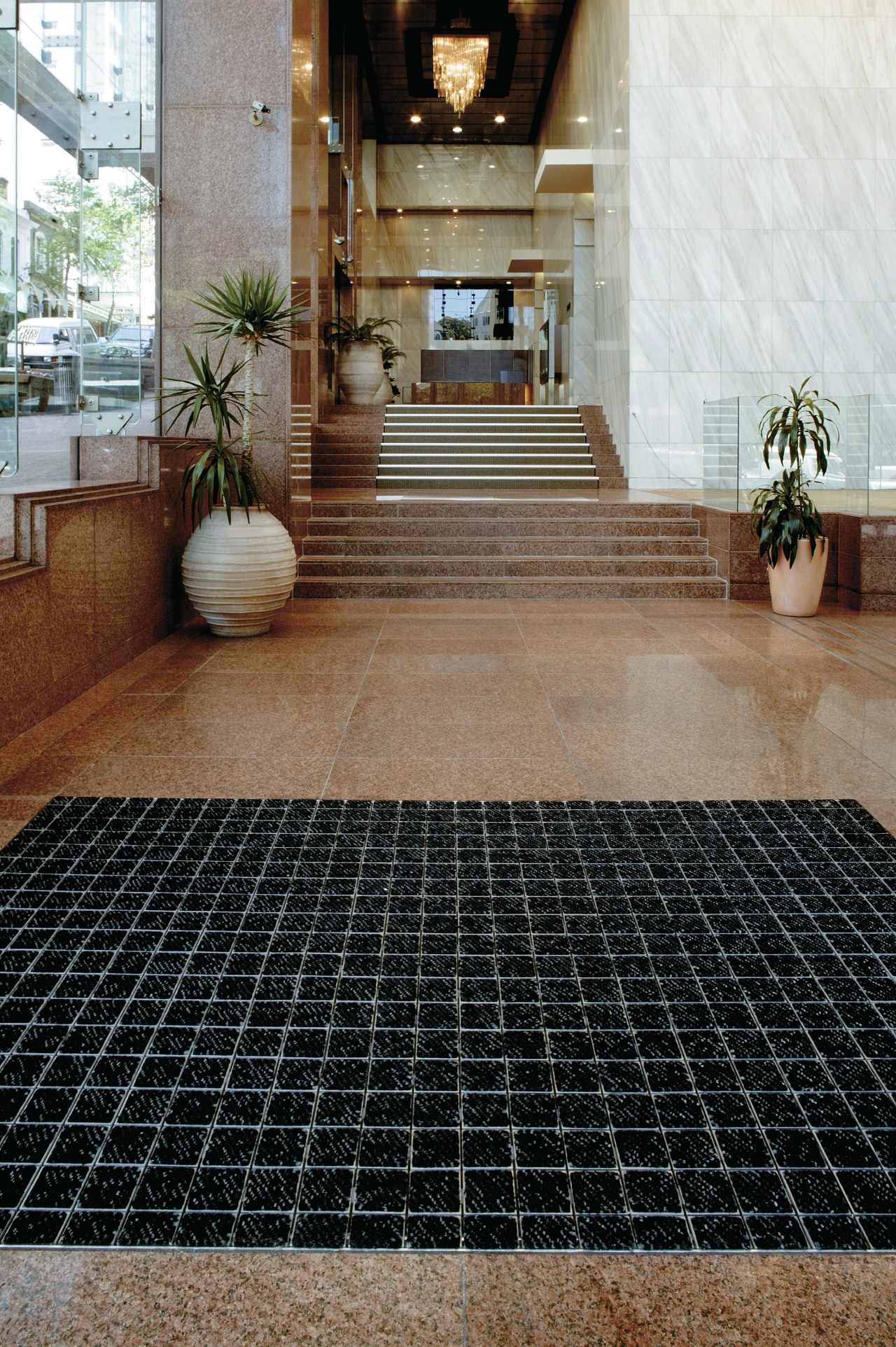 large mat in entrance area to protect tiled floor, flooring, road surface, tile, black, brown