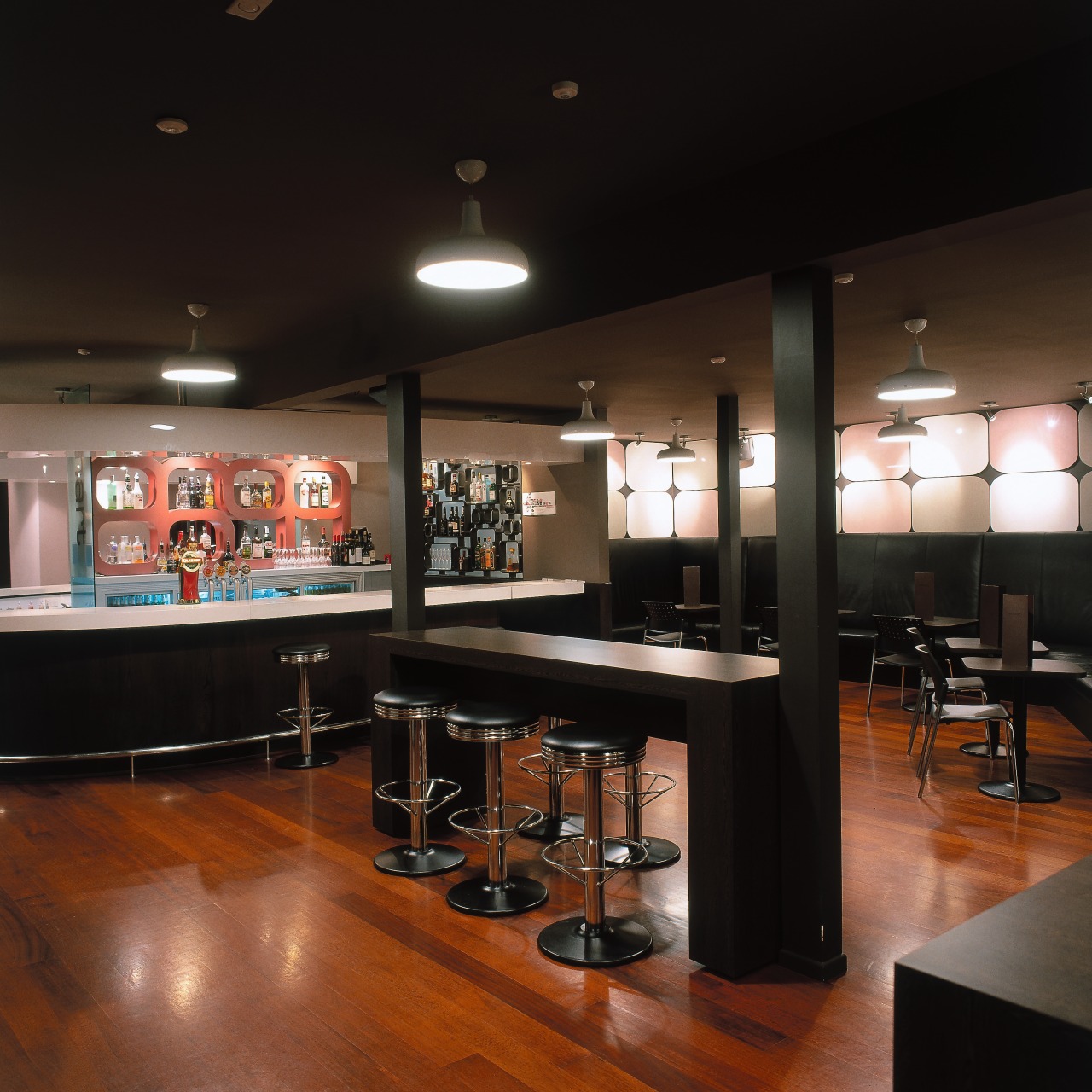 Bar interior with extensive wooden flooring shown bar, furniture, interior design, restaurant, table, black