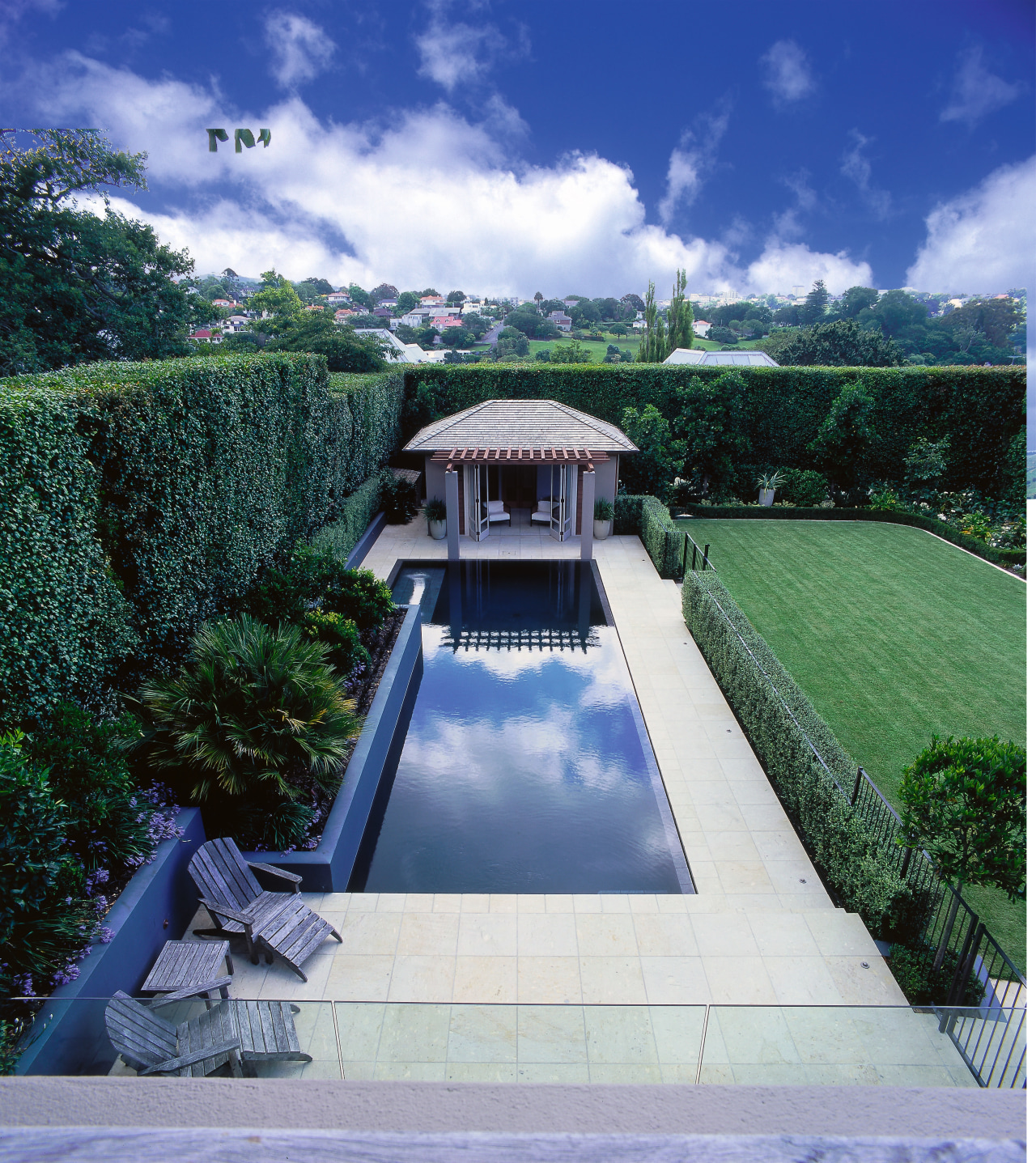 The pool adjoins a large flat lawn. architecture, cloud, estate, grass, house, landscape, property, real estate, reflecting pool, roof, sky, swimming pool, water, water feature, water resources, blue