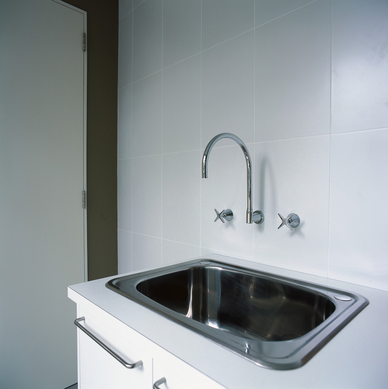 Closeup of laundry tub with wall mounted faucets. bathroom, bathroom sink, countertop, home appliance, kitchen, plumbing fixture, product design, sink, tap, gray