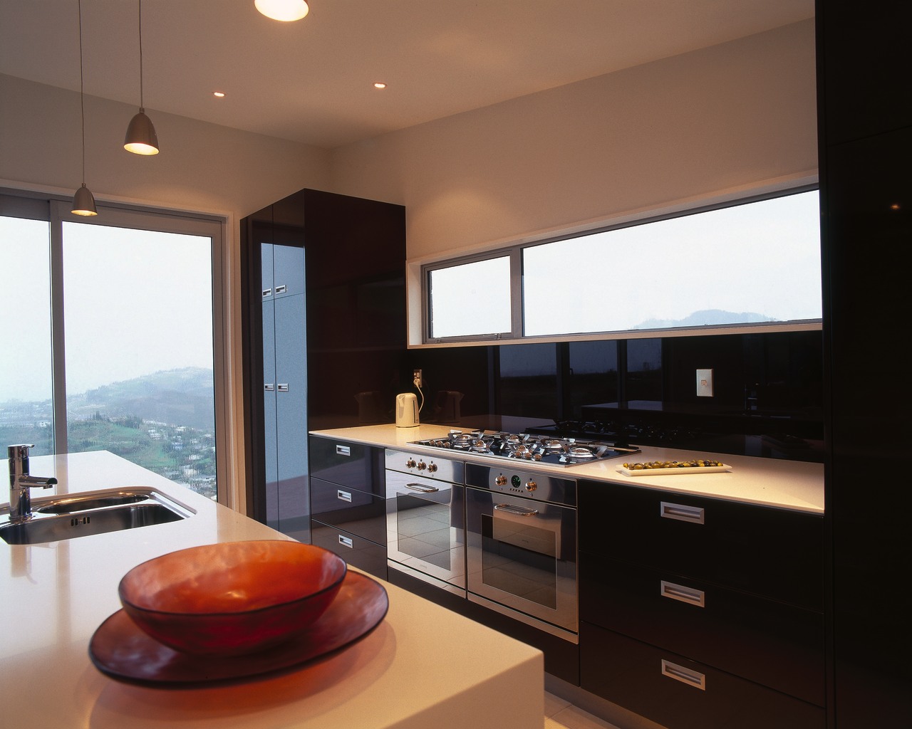 Kitchen with stainless steel ovens and gas cooktop, countertop, interior design, kitchen, real estate, black, brown