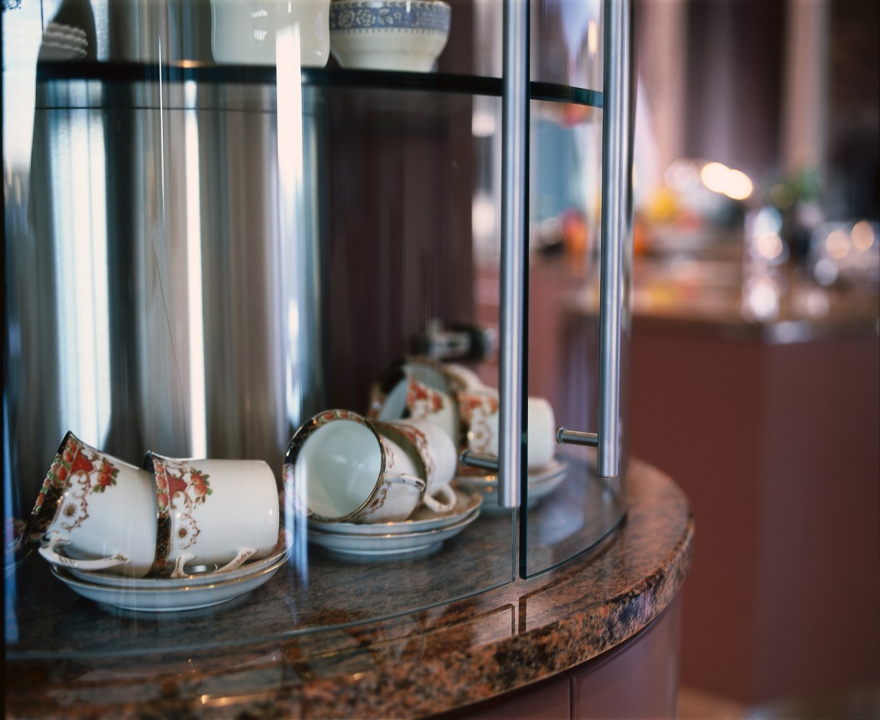 Closeup of fine china accessories in curved glass glass, table, gray, red