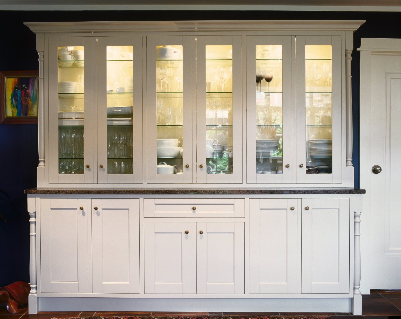 The detail of wooden cabinetry in a traditionally cabinetry, chest of drawers, cupboard, display case, furniture, shelf, shelving, window, wood stain, white
