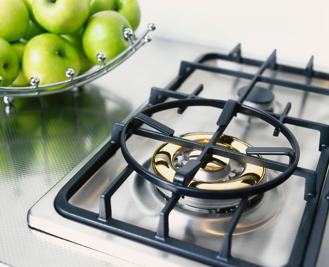 Gas hob cooktop set on textured stainless steel product design, white