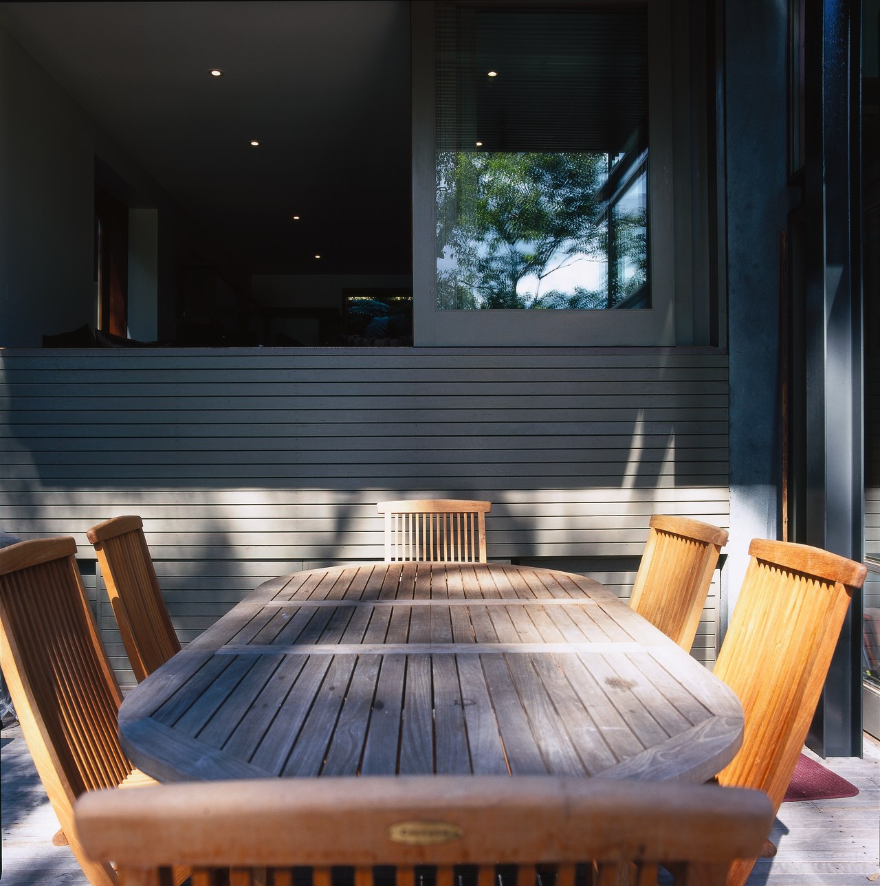 Wooden outdoor dining table and chairs on patio, architecture, chair, daylighting, floor, furniture, hardwood, interior design, lighting, outdoor furniture, table, wood, black