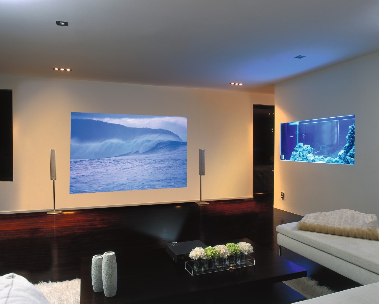 A photograph of a media room featuring a ceiling, display device, flat panel display, home, interior design, lighting, living room, multimedia, projection screen, room, gray