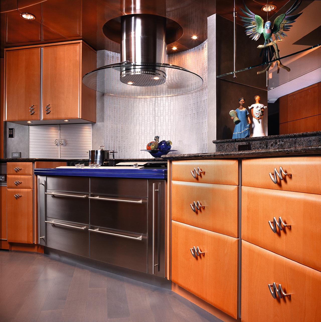 Inner view of the kitchen cabinetry &amp; appliances cabinetry, countertop, cuisine classique, flooring, hardwood, home appliance, interior design, kitchen, kitchen stove, room, under cabinet lighting, orange