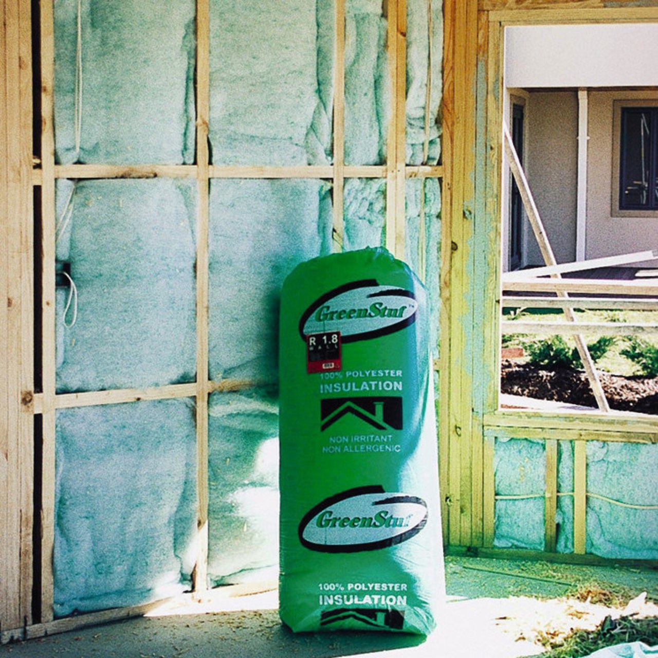 View of a bag of GreenStuf insulation. There green, wall, window, green