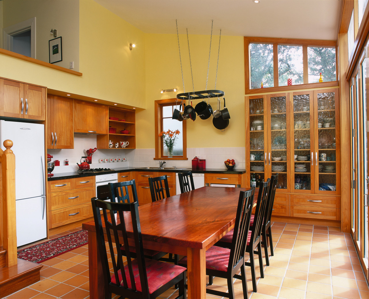 Traditional kitchen with macrocarpa cabinetry, glass doors in dining room, flooring, hardwood, interior design, kitchen, property, real estate, room, table, wood, orange, brown