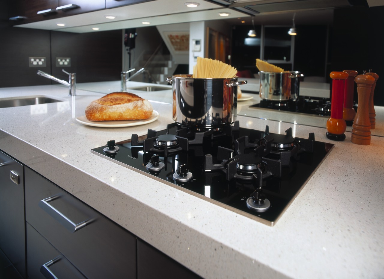 Four burner gas ceramic cooktop set into white countertop, kitchen, small appliance, black, gray