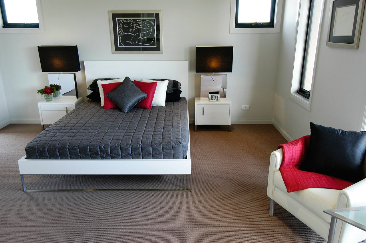 The bedroom of this home bed, bed frame, bedroom, floor, flooring, furniture, home, interior design, room, suite, gray