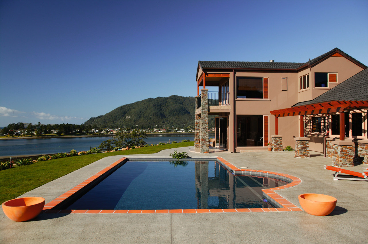 Dark blue pool with terracotta coloured paved edge, architecture, estate, home, house, leisure, property, real estate, residential area, resort, sky, swimming pool, vacation, villa, water, blue