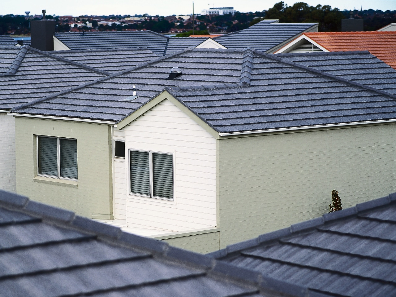 White house with grey coloured concrete roof tiles, daylighting, facade, home, house, outdoor structure, real estate, residential area, roof, siding, window, blue