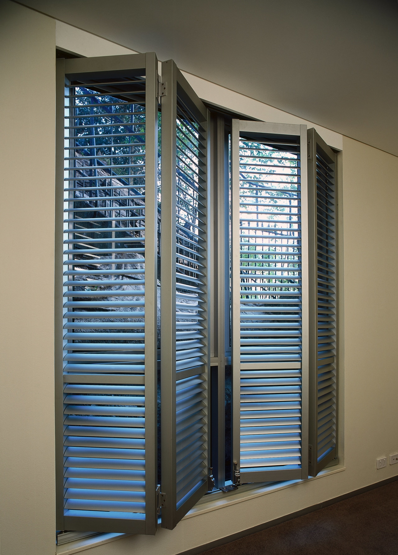 Bifolding louvres partly folded back. door, glass, window, window blind, window covering, window treatment, black, gray