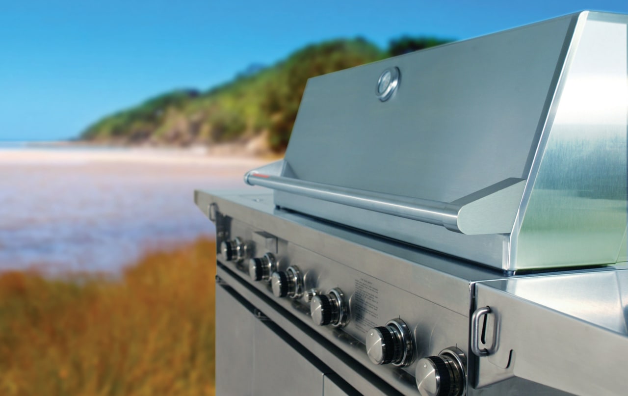 Stainless steel barbeque with hood and beach in teal, gray