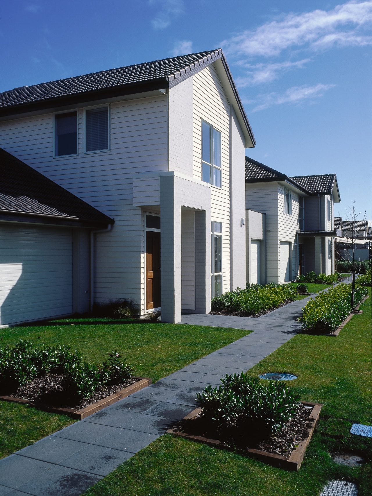 View of the homes architecture, backyard, building, cottage, elevation, estate, facade, grass, home, house, landscaping, lawn, neighbourhood, property, real estate, residential area, siding, sky, suburb, window, yard