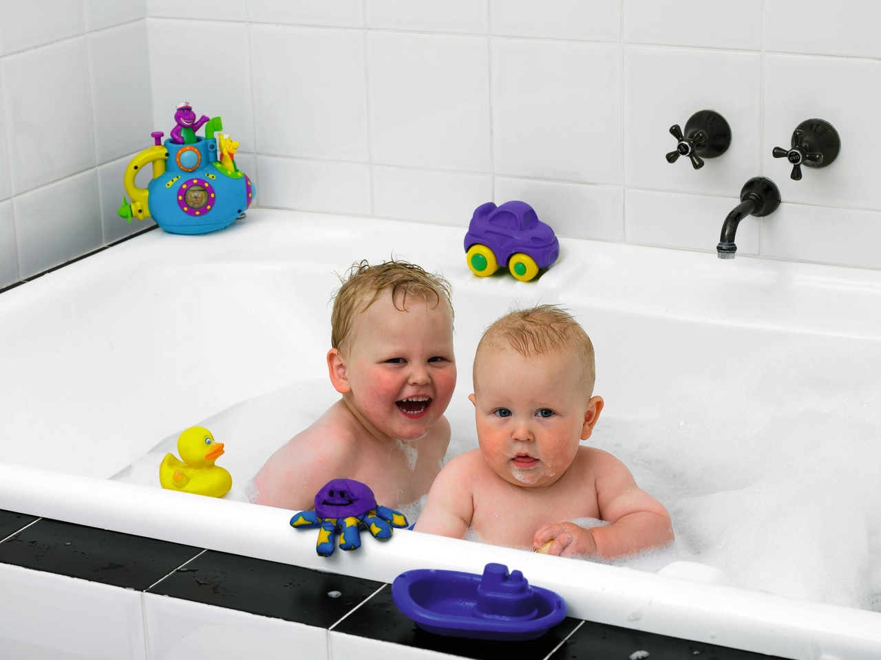 View of a bathtub with kids in it bathing, bathroom, bathtub, child, fun, infant, plumbing fixture, product, room, toddler, white