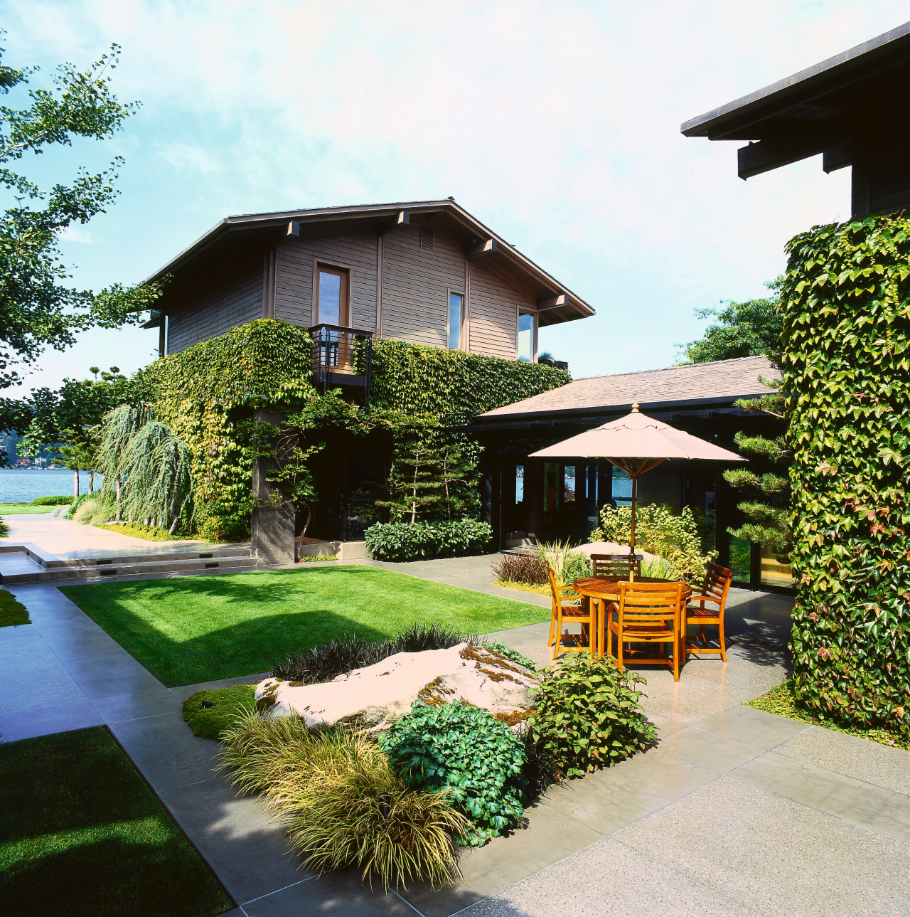 View of the backyard backyard, cottage, estate, facade, garden, grass, home, house, landscape, landscaping, lawn, outdoor structure, property, real estate, residential area, roof, yard, white