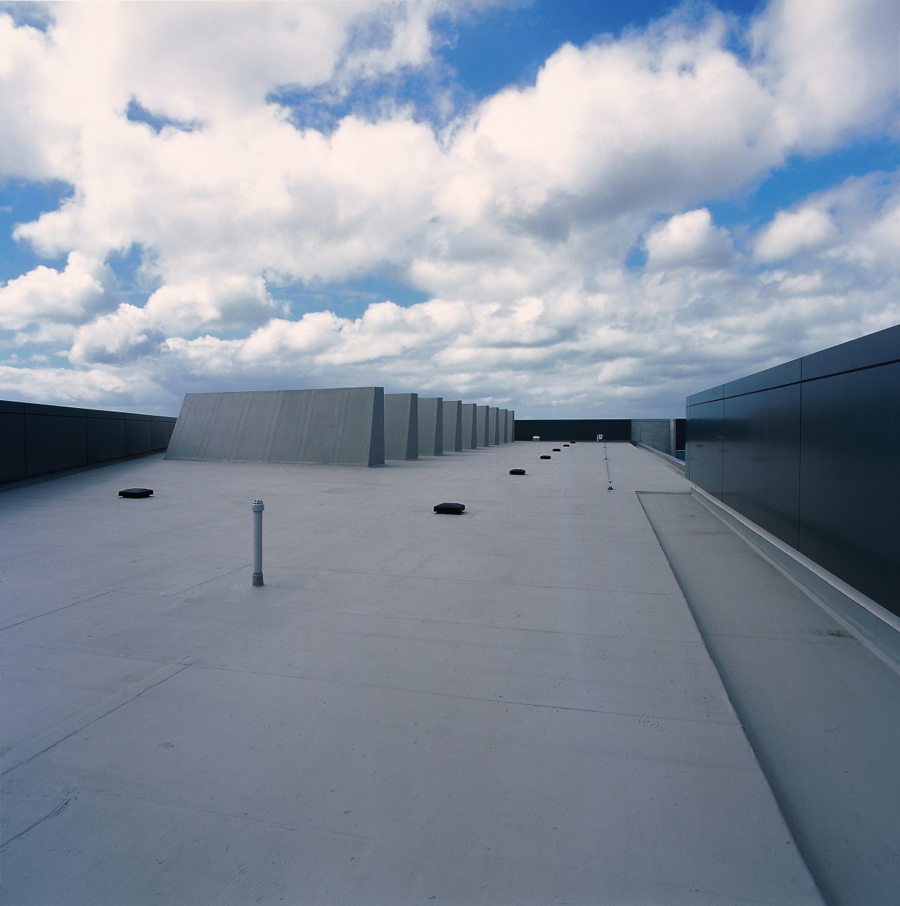 Waterproof roofing has been used on this section architecture, asphalt, cloud, daylighting, daytime, fixed link, horizon, infrastructure, line, road, road surface, roof, sky, sunlight, gray