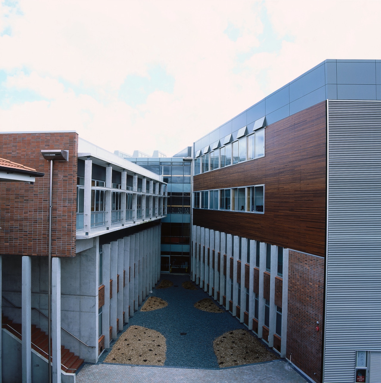 Exterior of building with central garden, showing concrete apartment, architecture, building, commercial building, corporate headquarters, facade, house, mixed use, real estate, residential area, white, black