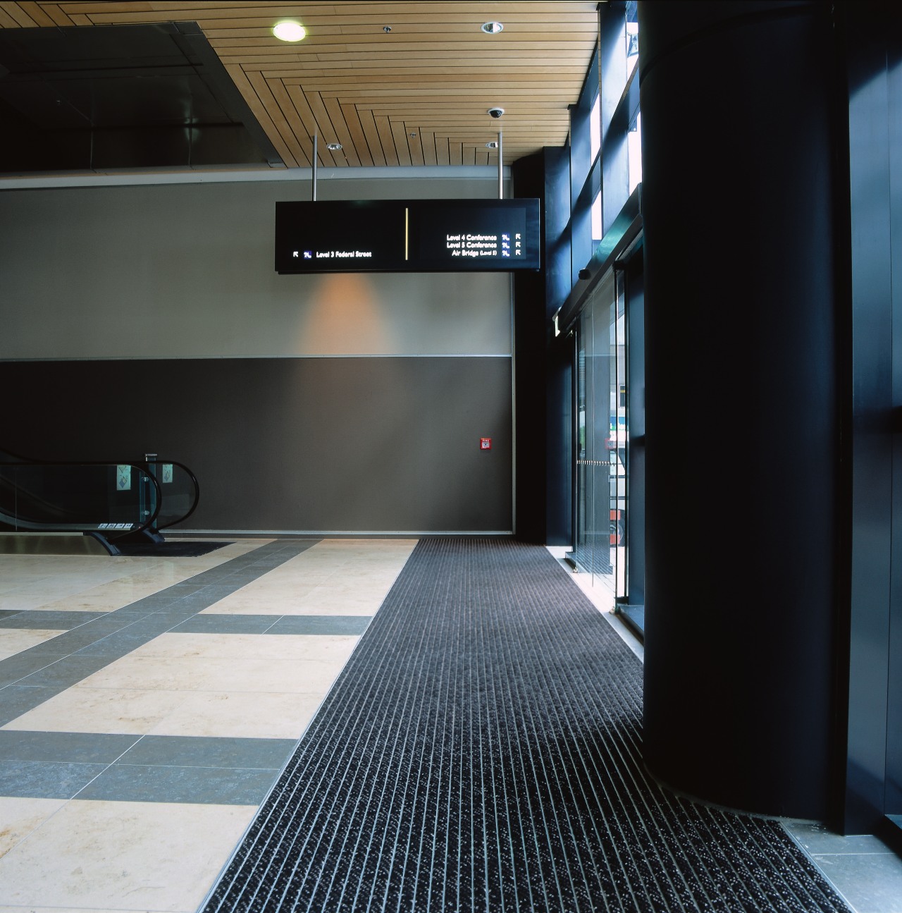 Entrance way of convention centre with long striped architecture, floor, flooring, black
