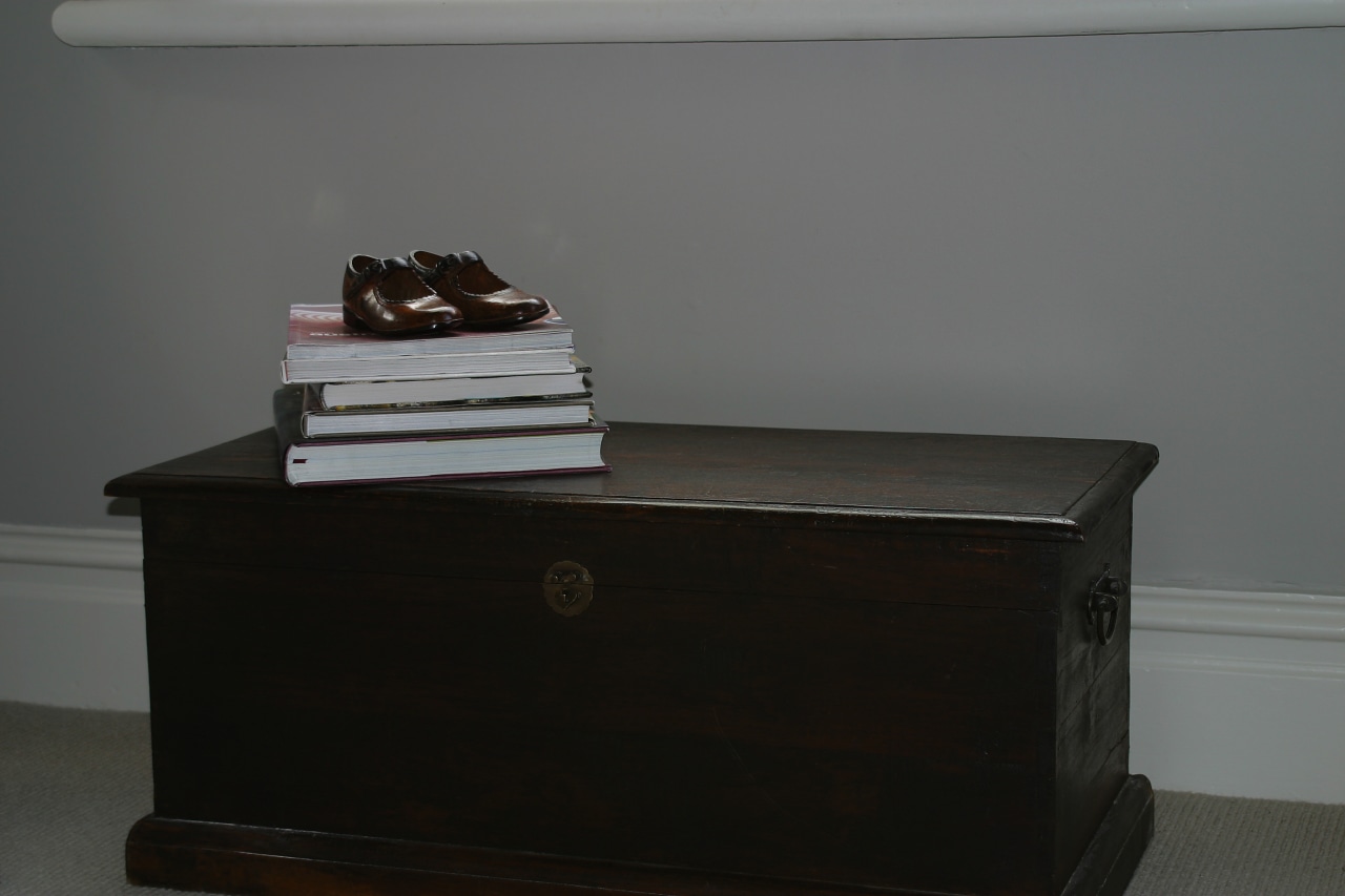 Timber chest with books on top, and neutral chest of drawers, furniture, table, gray, black