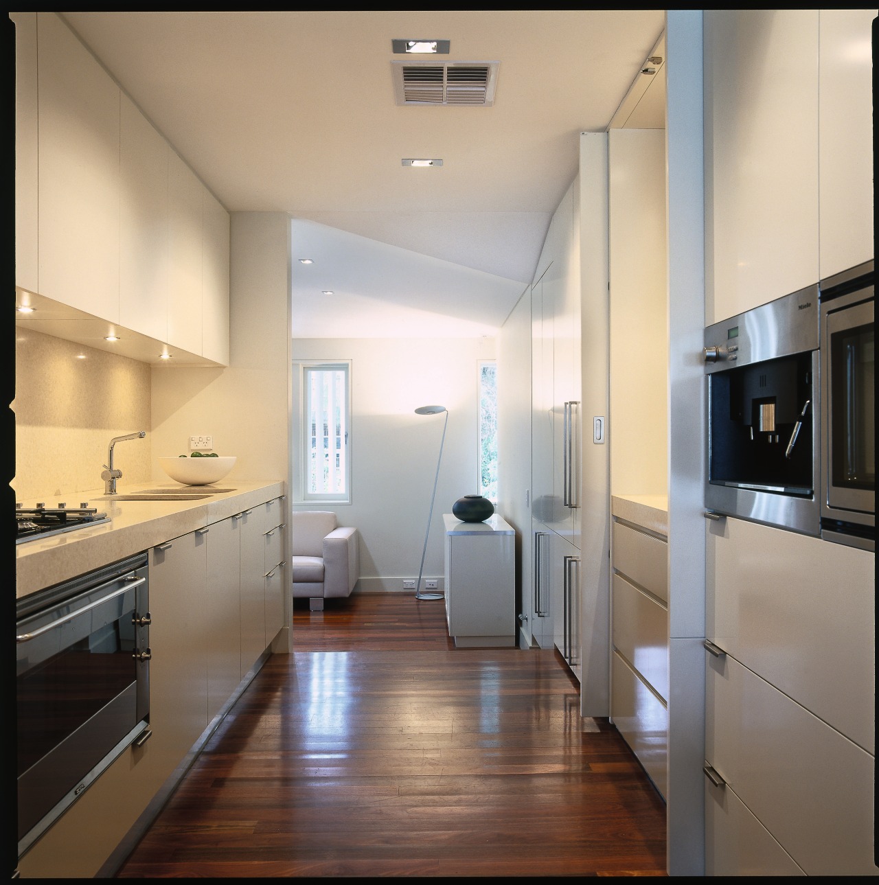 view of the kitchen area showing kitchen cabinetry, cabinetry, ceiling, countertop, floor, home appliance, interior design, kitchen, real estate, room, gray