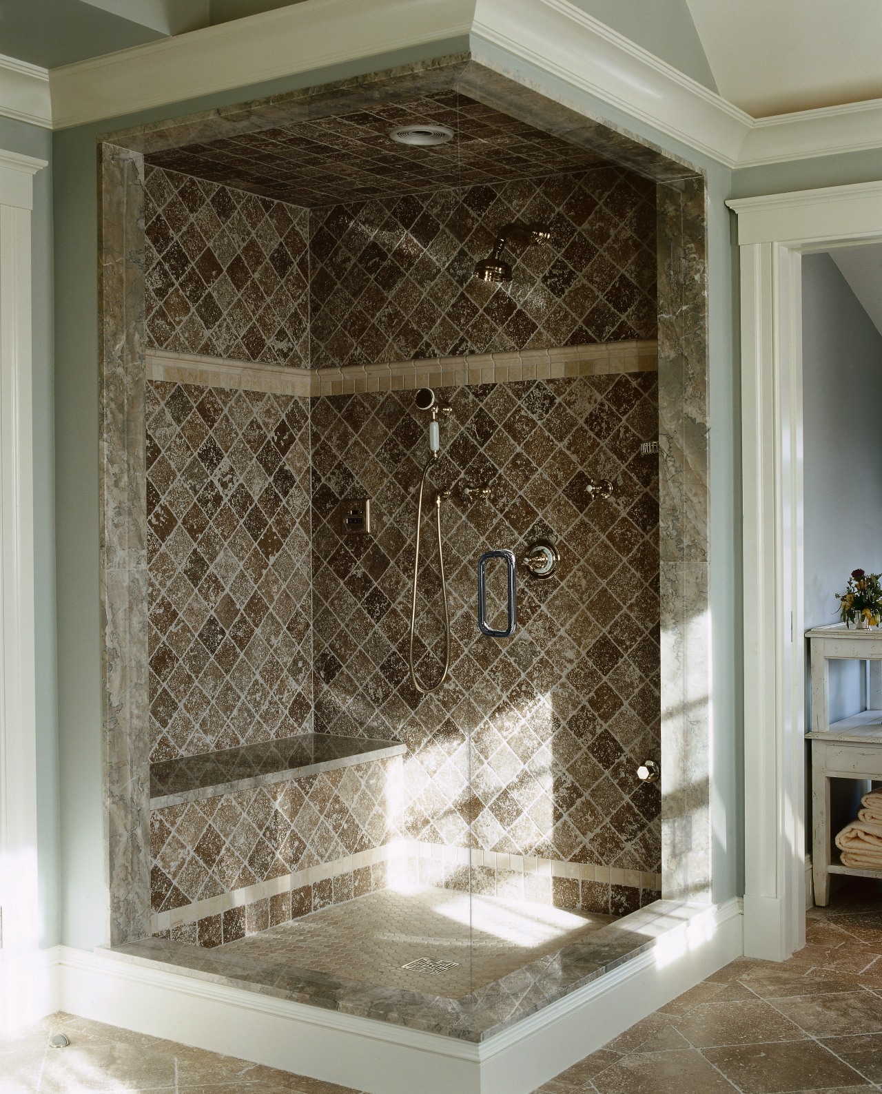 View of a large glass floor-to-ceiling shower, brown floor, flooring, glass, interior design, plumbing fixture, tile, wall, gray, brown