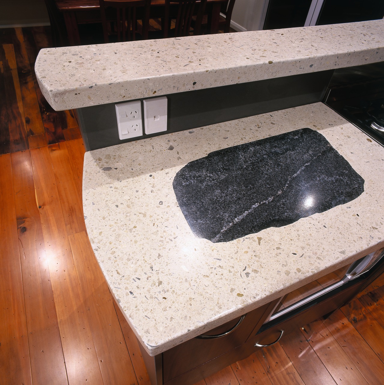 Closeup of light coloured polished concrete benchtop and countertop, floor, furniture, granite, material, table, wood, wood stain, white, brown