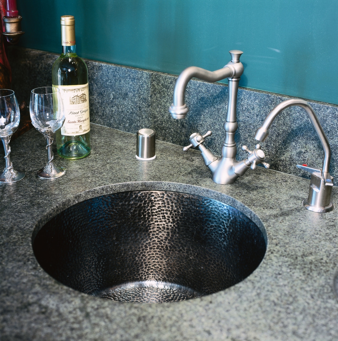 Close up view of a solid brass sink, glass, sink, tap, water, gray, black