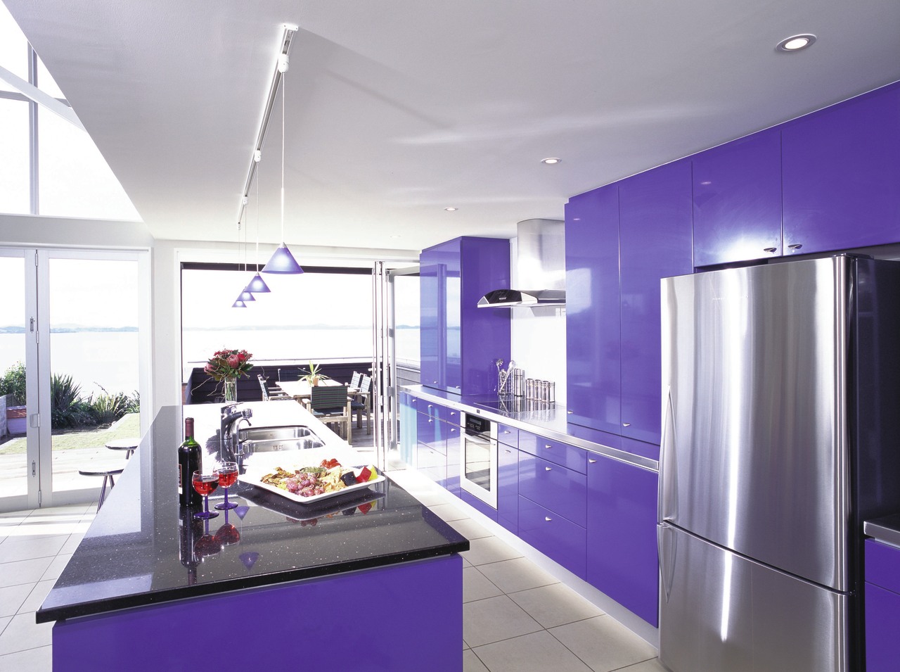 Open plan kitchen with blue cabinetry, folding doors countertop, interior design, kitchen, product design, purple, gray