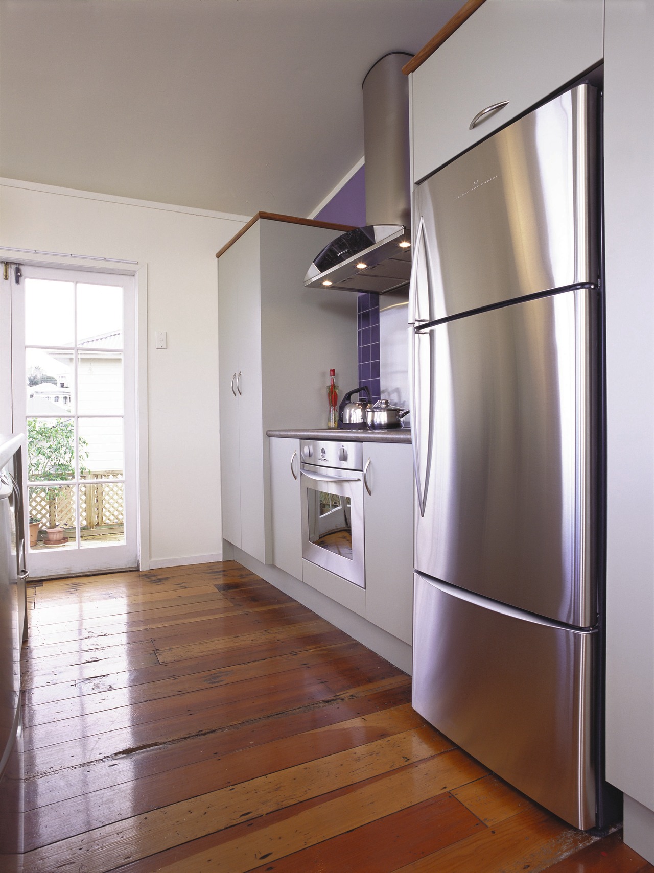 Kitchen with light grey cabinetry, three door stainless door, floor, home, home appliance, interior design, kitchen, real estate, room, gray