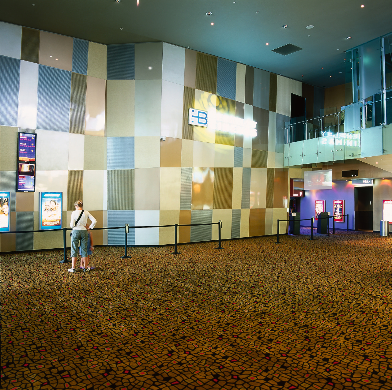 Large feature wall with perforated metal panels at architecture, floor, flooring, interior design, lobby, brown