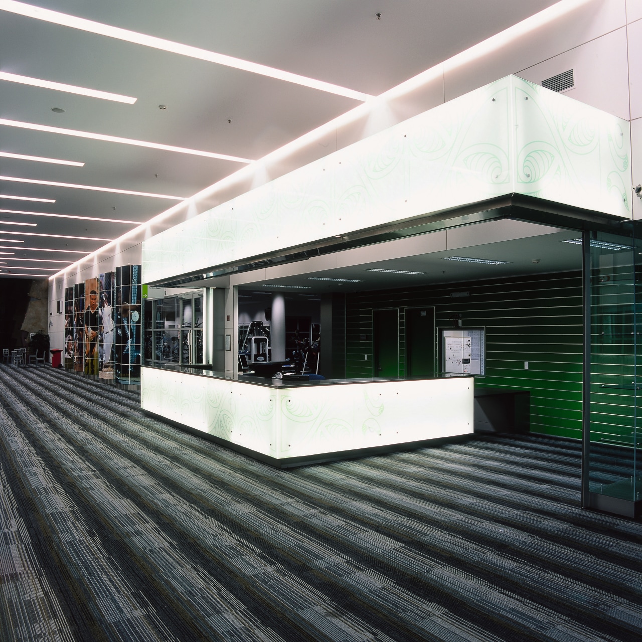 Lobby area of stadium building with backlit koru architecture, daylighting, black, white, gray