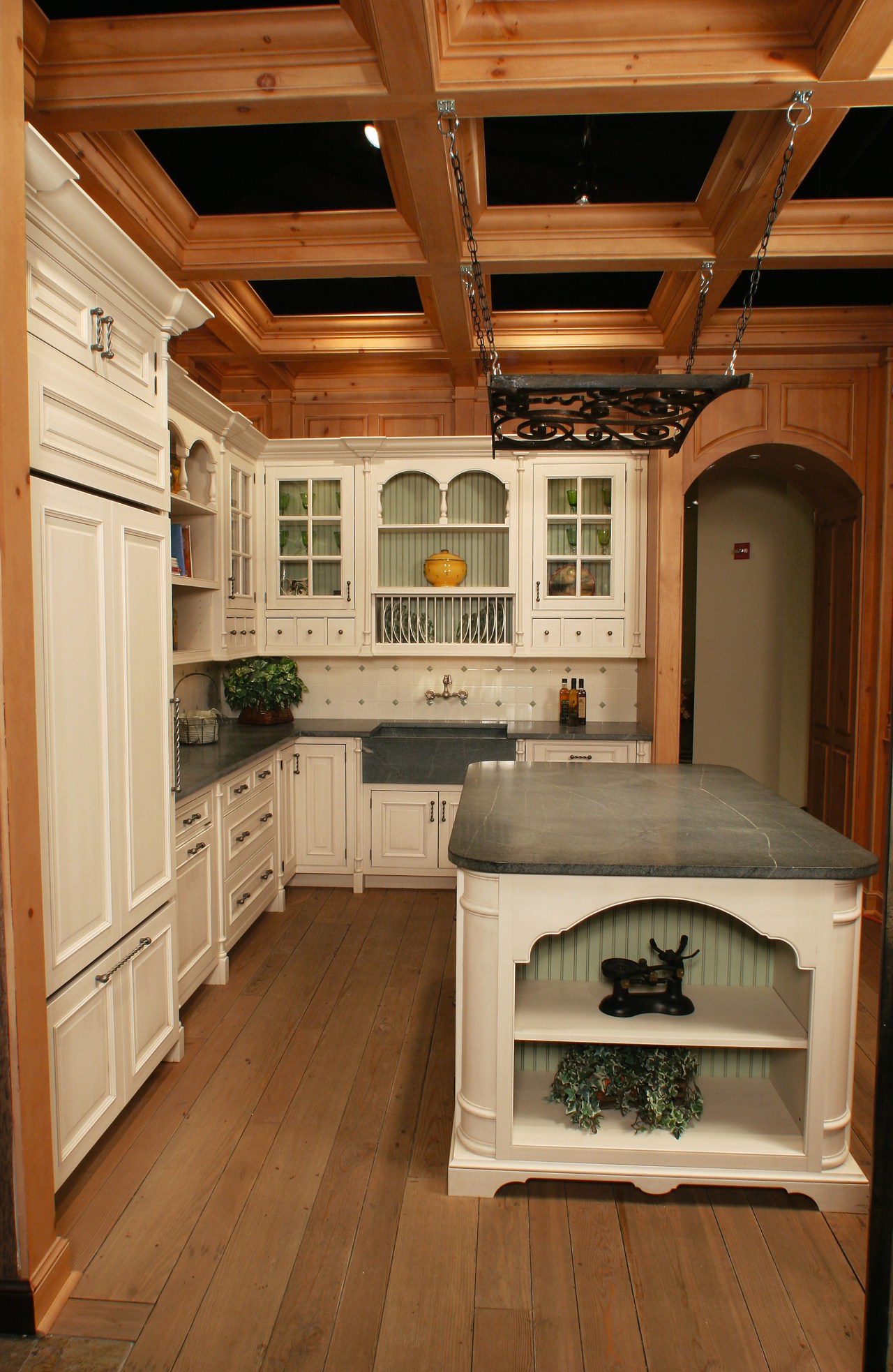 view of this unque kitchen showing elaborate timber cabinetry, ceiling, countertop, cuisine classique, floor, flooring, hardwood, home, home appliance, interior design, kitchen, laminate flooring, room, wood flooring, wood stain, brown, orange