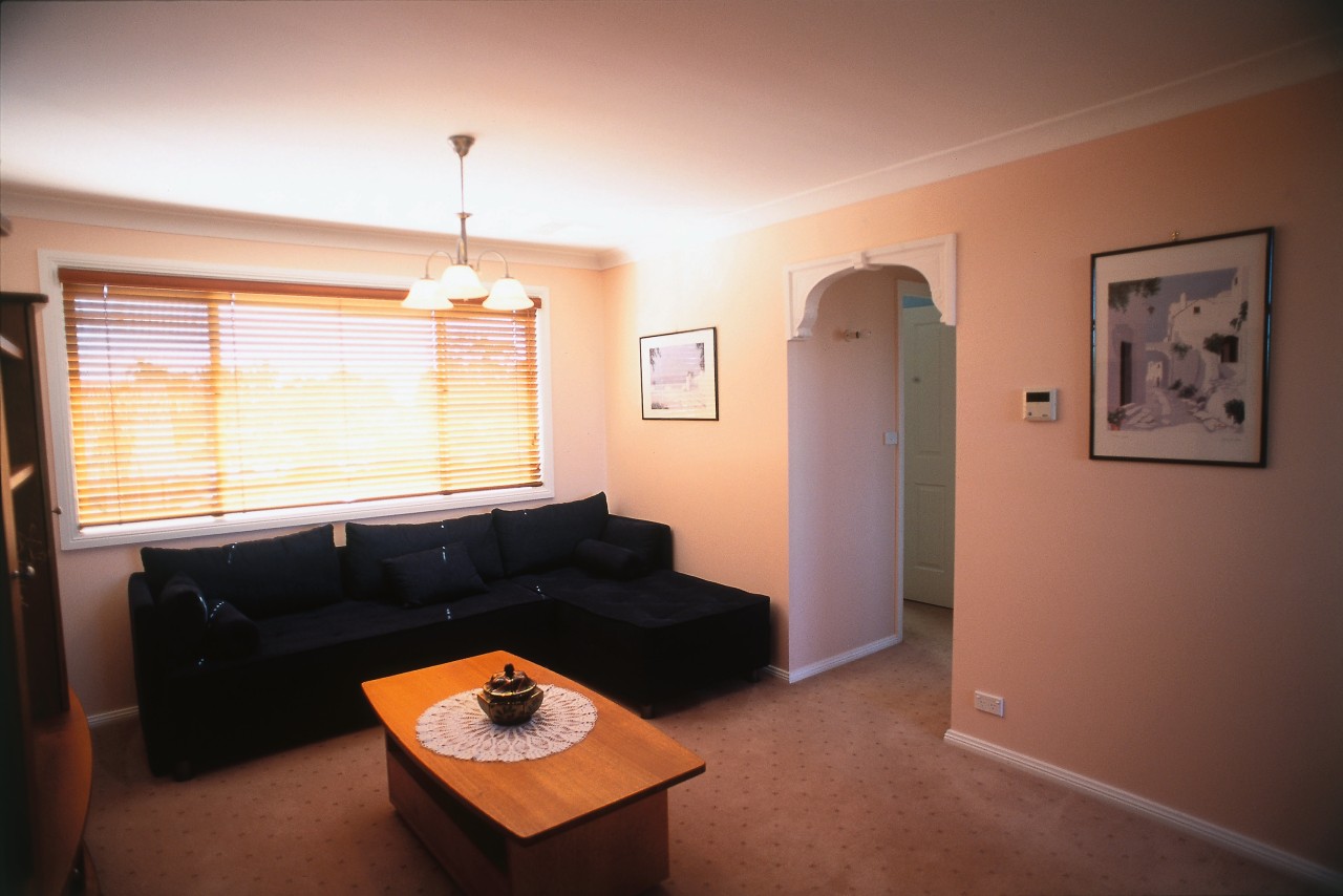 Living room with dark sofa, coffee table, carpet, apartment, ceiling, daylighting, floor, home, house, interior design, living room, property, real estate, room, window, wood, red