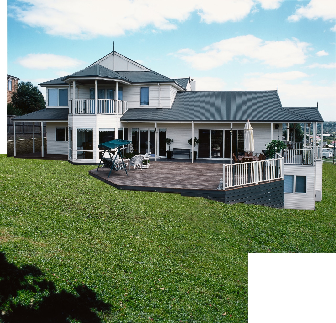 Exterior of large home with white weatherboards, large cottage, elevation, estate, facade, farmhouse, grass, home, house, land lot, property, real estate, residential area, siding, window, white